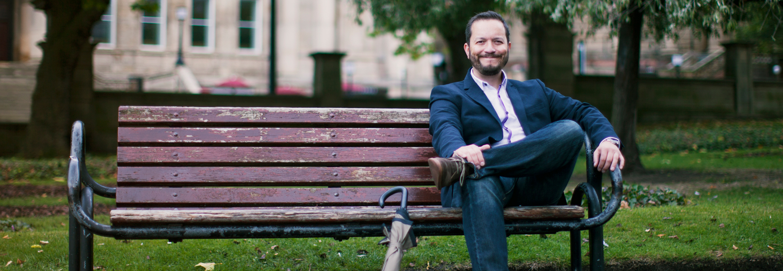 Photograph of Colin Scotland on a park bench